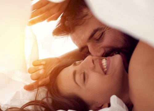 Happy couple in bed after PRP for sexual dysfunction treatments