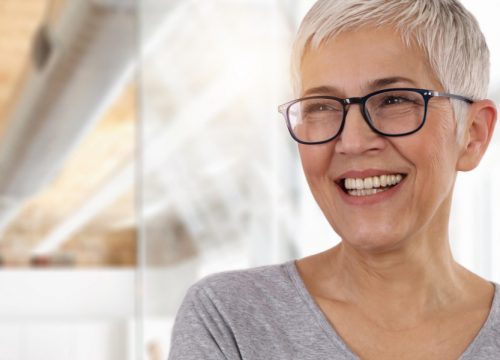 Smiling older woman with short hair and glasses